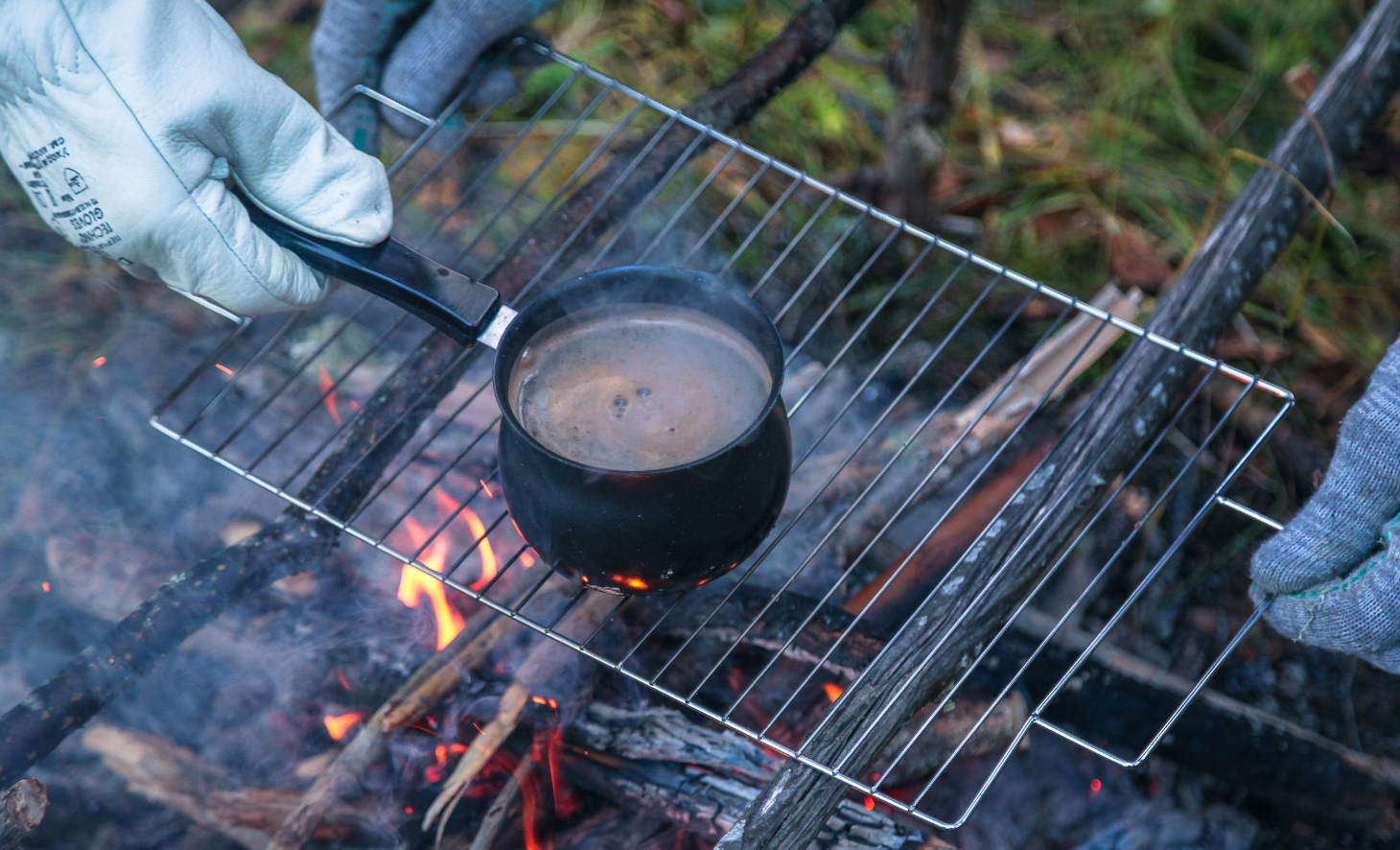 cowboy coffee pot boiling over open campfire burn steam cook